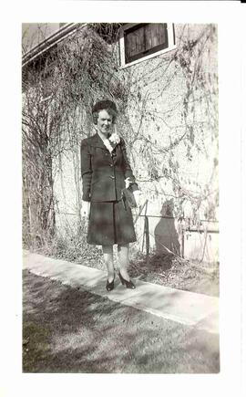 Edna Diefenbaker standing outside her home