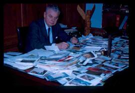 John Diefenbaker with cards spread on desk
