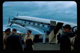 John and Olive Diefenbaker on tarmac beside airplane