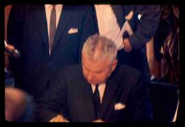 John Diefenbaker, signing documents