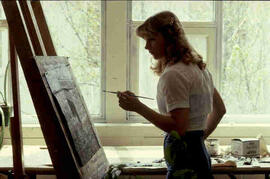 [Student painting at easel]
