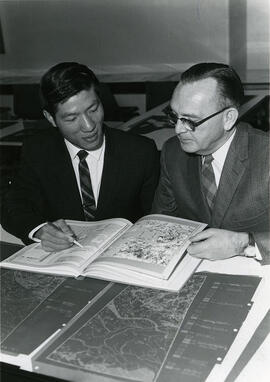 Dr. Ka-iu Fung and Dr. J. Howard Richards with Atlas of Saskatchewan