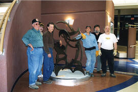 Saskatoon artist Leslie Potter, second from left, supervises a group helping him install his extr...