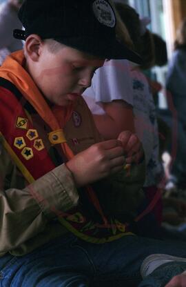 Boy scout making a bracelet
