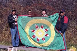 Senator Ernest Mike, Vance McNab, Freddy Spyglass and one other holding star blanket made in hono...