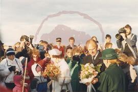 Queen Elizabeth II and Prince Philip greeting visitors and accepting flowers