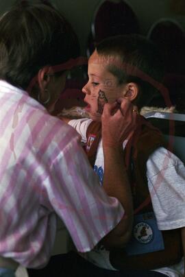 Person painting child's face