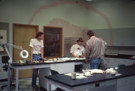Chuck Ramsay explaining archaeology to guest