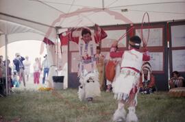 Bill Brittain and child performing hoop dance