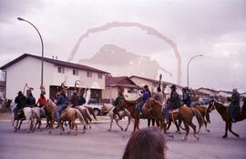 People on horseback holding sacred eagle staffs at Russell road and Adilman drive