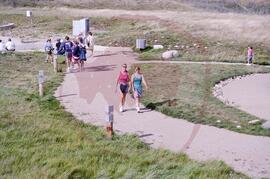 Visitors walking along path from amphitheatre