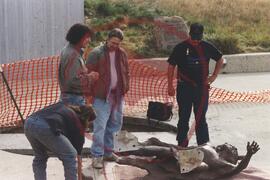 Lloyd Pinay and three others regarding bronze bison calf runner sculpture ready for installation