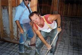 People pouring concrete flooring